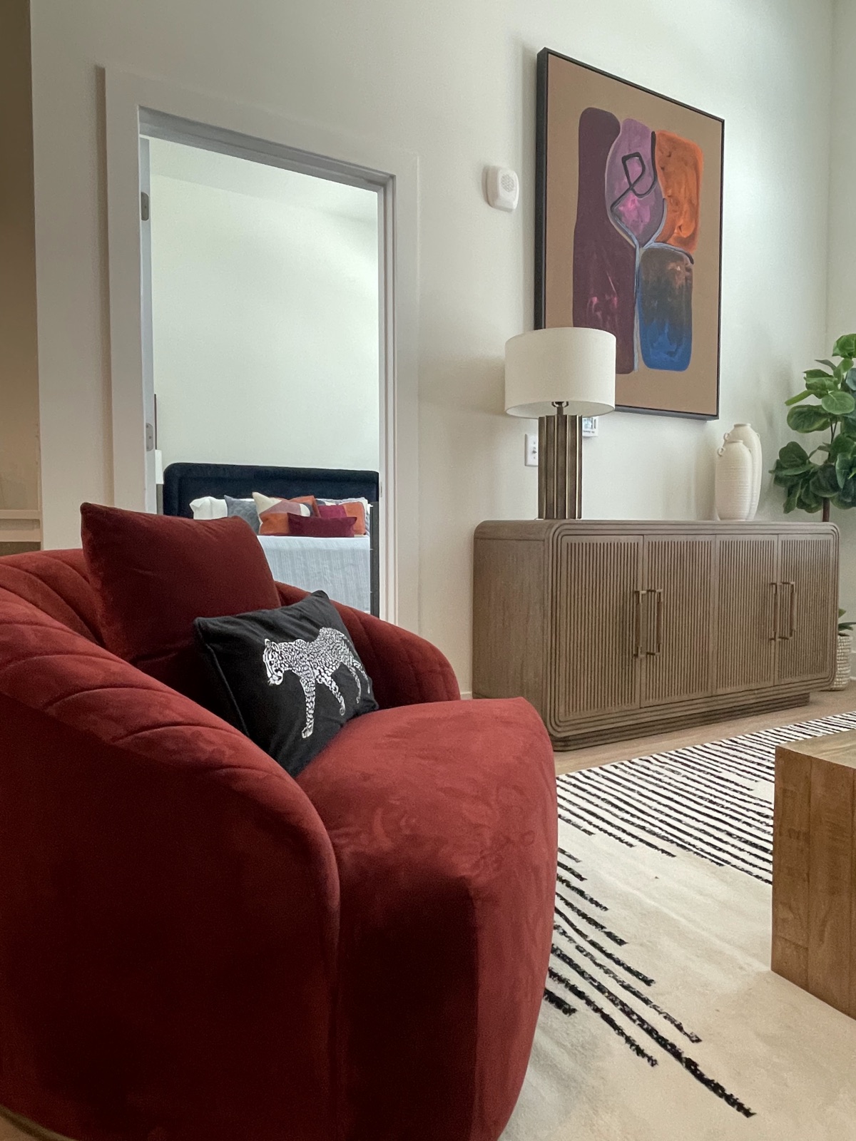 The Assembly, red velvet sofa with layered art