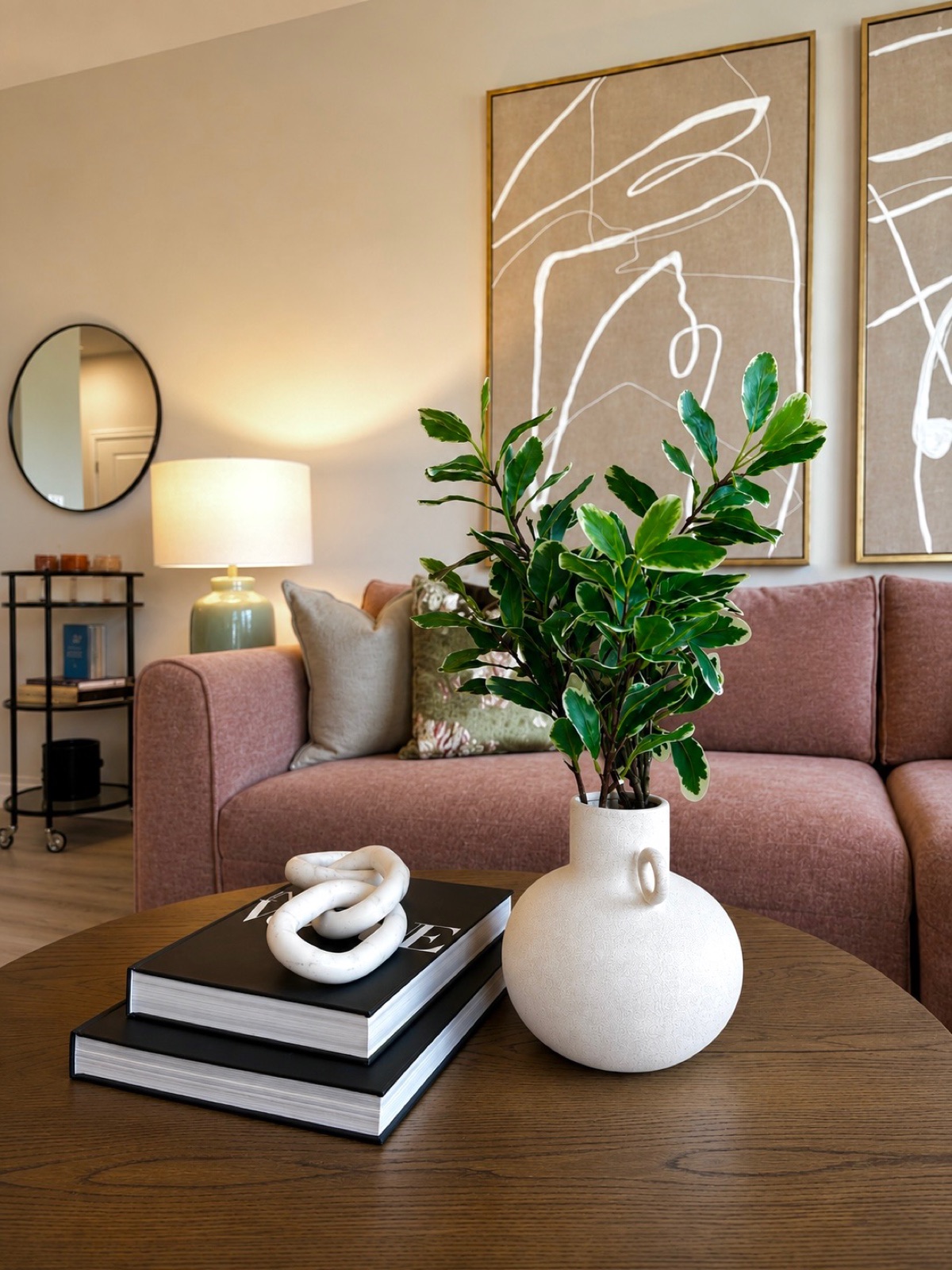 Moorefield, living room with mauve sofa and line-art diptych