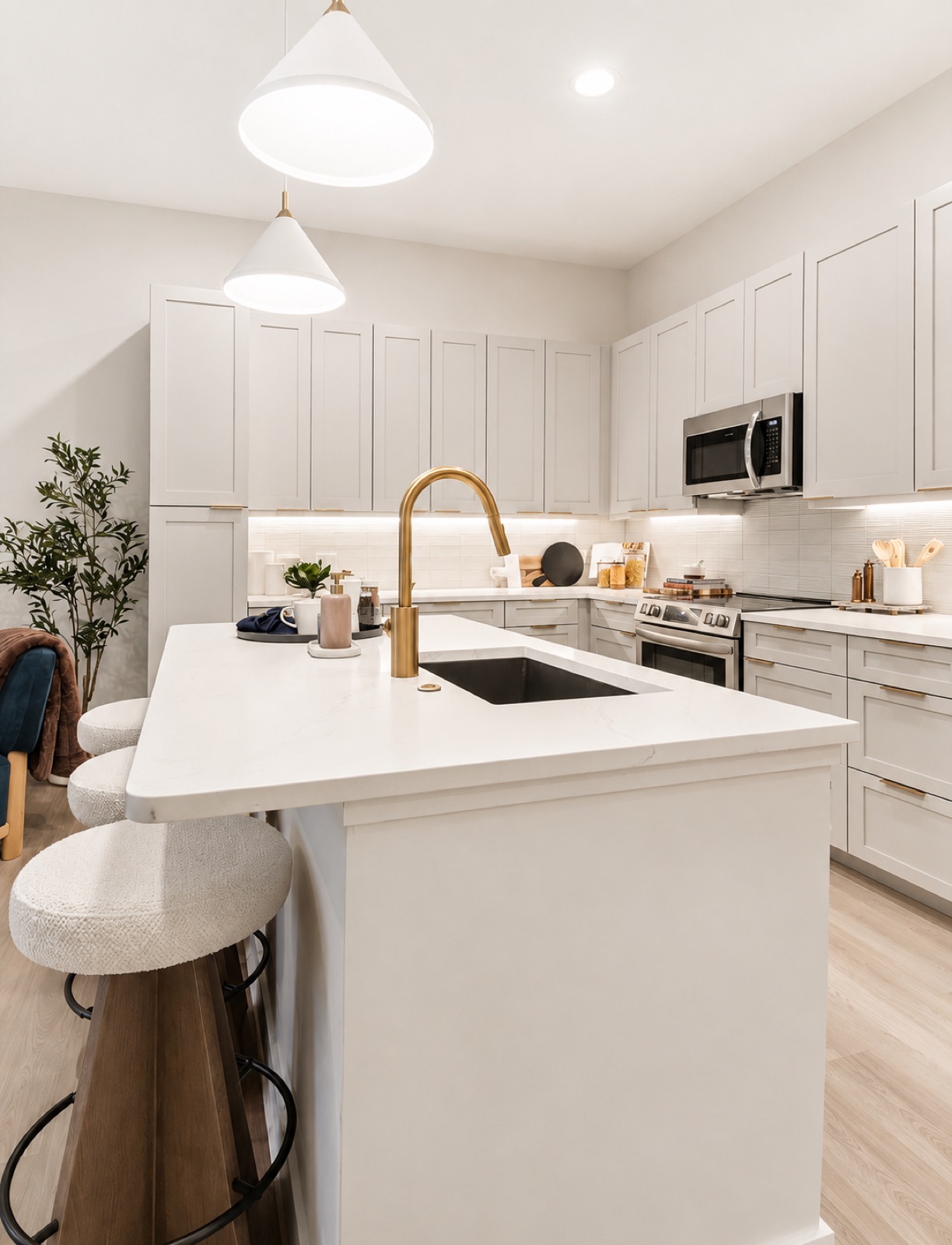 The Residence Peninsula, white kitchen with brass fixtures